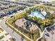Aerial shot of the community with a playground and resort-style pool surrounded by lush landscaping at 2839 Gumbo Limbo Dr, Wimauma, FL 33598