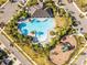 Overhead view showcases the community pool, playground, parking, and lush greenery at 2839 Gumbo Limbo Dr, Wimauma, FL 33598