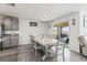 Open dining room with table, sliding glass doors to the backyard, and access to the kitchen at 2839 Gumbo Limbo Dr, Wimauma, FL 33598