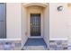 Close up of a front door entrance with neutral stucco and stone accents at 2839 Gumbo Limbo Dr, Wimauma, FL 33598