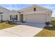 Beautiful single-Gathering home with a well-manicured lawn and two-car garage at 2839 Gumbo Limbo Dr, Wimauma, FL 33598
