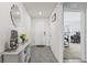 Bright hallway featuring a decorative mirror, console table, and view into an adjacent room at 2839 Gumbo Limbo Dr, Wimauma, FL 33598