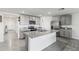 Modern kitchen with stainless steel appliances, gray cabinets, granite countertops, and a kitchen island at 2839 Gumbo Limbo Dr, Wimauma, FL 33598