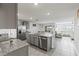 Open kitchen featuring stainless steel appliances, granite countertops and an island overlooking the dining and living areas at 2839 Gumbo Limbo Dr, Wimauma, FL 33598