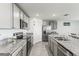 Modern kitchen with stainless steel appliances, granite countertops, and light gray cabinets at 2839 Gumbo Limbo Dr, Wimauma, FL 33598