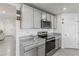 Kitchen featuring gray cabinets, granite countertops, and stainless steel appliances at 2839 Gumbo Limbo Dr, Wimauma, FL 33598