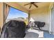 Cozy covered lanai with ceiling fan and curtains featuring view of fenced in back yard at 2839 Gumbo Limbo Dr, Wimauma, FL 33598