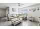 Bright living room with a sectional sofa, ceiling fan, tile flooring, and lots of natural light at 2839 Gumbo Limbo Dr, Wimauma, FL 33598