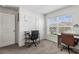 Bright home office featuring two modern desks with chairs, and a window with neighborhood views at 2839 Gumbo Limbo Dr, Wimauma, FL 33598