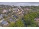 Scenic aerial view of a home near the coast with lush trees and winding waterways at 3038 Longbrooke Way, Clearwater, FL 33760