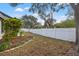 Fenced backyard with landscaping and mature trees provides privacy and space for outdoor enjoyment at 3038 Longbrooke Way, Clearwater, FL 33760