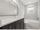 Modern bathroom with a new vanity, mirror, and subway tile at 3038 Longbrooke Way, Clearwater, FL 33760