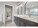 Bathroom with double vanity, modern lighting, framed mirrors and access to the screened porch at 3038 Longbrooke Way, Clearwater, FL 33760