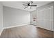 Bedroom featuring wood-look floors, neutral paint and ceiling fan at 3038 Longbrooke Way, Clearwater, FL 33760
