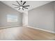 Spacious bedroom featuring high ceilings, modern ceiling fan, and light wood floors at 3038 Longbrooke Way, Clearwater, FL 33760