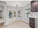 Bright dining nook with wood-look floors and sliding glass doors leading outside at 3038 Longbrooke Way, Clearwater, FL 33760