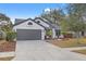 Charming one-story home with a beautifully landscaped front yard, fresh mulch, and healthy plants at 3038 Longbrooke Way, Clearwater, FL 33760