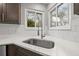 Bright kitchen with stainless steel sink and subway tile backsplash at 3038 Longbrooke Way, Clearwater, FL 33760
