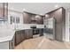 Kitchen features stainless steel appliances, dark cabinets, modern fixtures and hardwood floors at 3038 Longbrooke Way, Clearwater, FL 33760