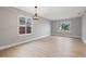Living room featuring neutral walls, wood-look floors, and decorative light fixture at 3038 Longbrooke Way, Clearwater, FL 33760