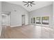 Bright living room with vaulted ceilings, wood floors, and sliding glass doors to the lanai at 3038 Longbrooke Way, Clearwater, FL 33760