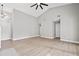 Open living room featuring high ceilings, neutral paint, and modern ceiling fan at 3038 Longbrooke Way, Clearwater, FL 33760