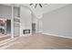 Spacious living room features fireplace, shelves, neutral paint and wood-look floors at 3038 Longbrooke Way, Clearwater, FL 33760