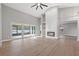 Large living room with fireplace, sliding glass doors, high ceilings, and wood-look floors at 3038 Longbrooke Way, Clearwater, FL 33760