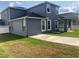 Expansive backyard featuring green grass and partial view of the screened in patio offers outdoor tranquility at 4446 Wildstar Cir, Wesley Chapel, FL 33544