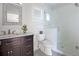 Bright bathroom featuring a vanity with marble countertop and a glass-enclosed shower with white subway tile at 445 13Th Ne Ave, St Petersburg, FL 33701