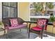 Comfortable seating with patterned pillows on a covered front porch, perfect for relaxing and enjoying the outdoors at 445 13Th Ne Ave, St Petersburg, FL 33701