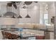 This is a bright kitchen with custom vent hood, stainless steel appliances, and an island with barstool seating at 445 13Th Ne Ave, St Petersburg, FL 33701