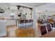 Open concept living space with hardwood floors seamlessly connecting the kitchen, living area, and breakfast bar seating at 445 13Th Ne Ave, St Petersburg, FL 33701