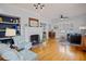 Spacious living room showcasing hardwood floors, a fireplace with tile surround, and built-in bookshelves at 445 13Th Ne Ave, St Petersburg, FL 33701