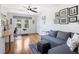 Stylish living area with a comfortable gray sofa, hardwood floors, and a workstation near the windows at 445 13Th Ne Ave, St Petersburg, FL 33701
