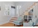 Cozy interior living room with staircase, built-in bookshelf, stylish chairs and hardwood floors at 445 13Th Ne Ave, St Petersburg, FL 33701