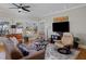 Comfortable living room with a leather sofa, armchairs, hardwood floors, and a large television at 445 13Th Ne Ave, St Petersburg, FL 33701