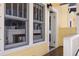Covered porch with a white railing, featuring a view of the home's bright yellow exterior at 445 13Th Ne Ave, St Petersburg, FL 33701