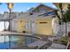 Poolside studio building featuring light yellow exterior paint and white trim at 445 13Th Ne Ave, St Petersburg, FL 33701