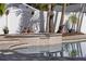 Close up of the home's spa, featuring a tile exterior, steps, and reflection in pool at 445 13Th Ne Ave, St Petersburg, FL 33701