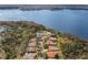 A high angle view of a home near a lake surrounded by trees and greenery at 4564 Juniper Dr, Palm Harbor, FL 34685