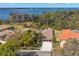 Aerial view of the home surrounded by lush greenery, showcasing lake views and neighborhood charm at 4564 Juniper Dr, Palm Harbor, FL 34685
