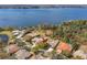 Aerial view of a lakeside home featuring mature landscaping and stunning water views at 4564 Juniper Dr, Palm Harbor, FL 34685