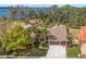 Aerial view of the home surrounded by lush greenery, showcasing lake views and neighborhood charm at 4564 Juniper Dr, Palm Harbor, FL 34685