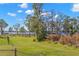 Spacious backyard featuring a well-manicured lawn and serene views of the adjacent lake at 4564 Juniper Dr, Palm Harbor, FL 34685