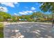 Outdoor basketball court features multiple hoops surrounded by mature trees at 4564 Juniper Dr, Palm Harbor, FL 34685
