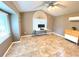 Neutral bedroom featuring ceiling fan, large window, tile floors, and a mini-split AC system at 4564 Juniper Dr, Palm Harbor, FL 34685
