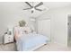 Bedroom features a ceiling fan, light gray walls, carpeted floors, and a bed with bedside tables and lamps at 4564 Juniper Dr, Palm Harbor, FL 34685