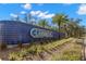 An entrance sign to the Lansbrook community enhanced by blue-tiled walls and lush greenery at 4564 Juniper Dr, Palm Harbor, FL 34685