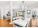Dining area with an open concept, hardwood floors, and a modern globe pendant light at 4564 Juniper Dr, Palm Harbor, FL 34685
